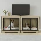 A modern, light wood double dog crate furniture console used as a TV stand, with a Jack Russell and a Cavalier King Charles Spaniel resting inside on white mats.