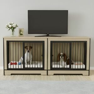 A modern, light wood double dog crate furniture console used as a TV stand, with a Jack Russell and a Cavalier King Charles Spaniel resting inside on white mats.