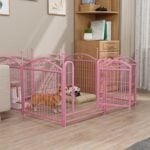 Pink metal dog playpen with two small dogs and a pink toy ball in a modern living room with light wood floors, white sofa, and bookshelves.
