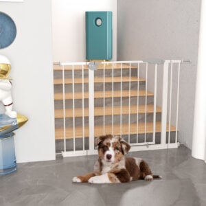 A pressure-mounted dog gate with a brown and white pup.